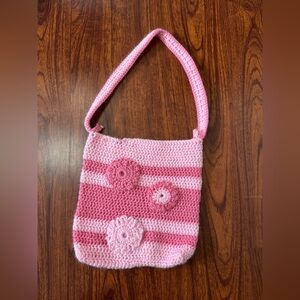 Handmade pink and light pink striped crochet shoulder bag with flower appliqués
